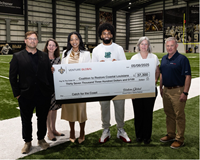 Venture Global presents a check donation to the Coalition to Restore Coastal Louisiana at the New Orleans Saints Ochsner Sports Performance Center.