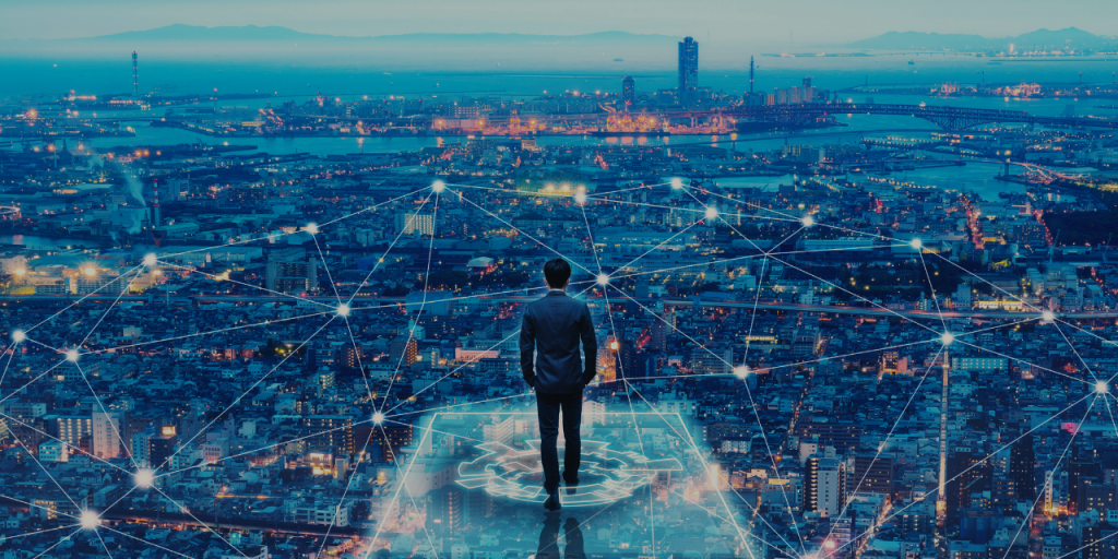a man standing on a high rise building with many lights